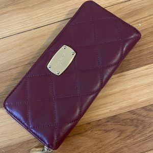 Cranberry, quilted Michael Kors wallet.